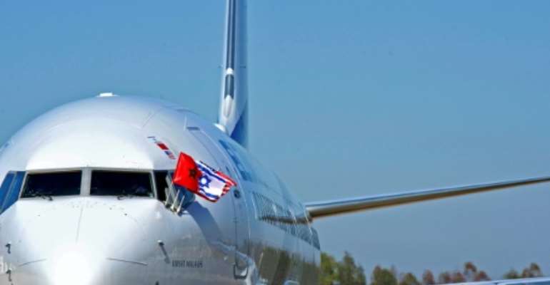 The flags of Morocco, Israel, and the United States flutter from the cockpit of an El Al airplane that landed in Morocco's capital Rabat for the first Israel-Morocco direct commercial flight on December 22, 2020. By - (US EMBASSY IN MOROCCO/AFP/File)