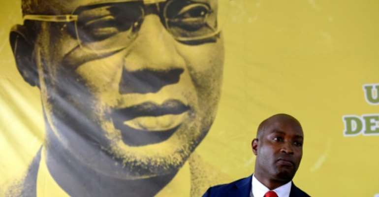 The founder of Guinea-Bissau's PAIGC party, Amilcar Cabral, looks down as spokesman Joao Bernardo Vieira speaks to the press. By SEYLLOU (AFP)