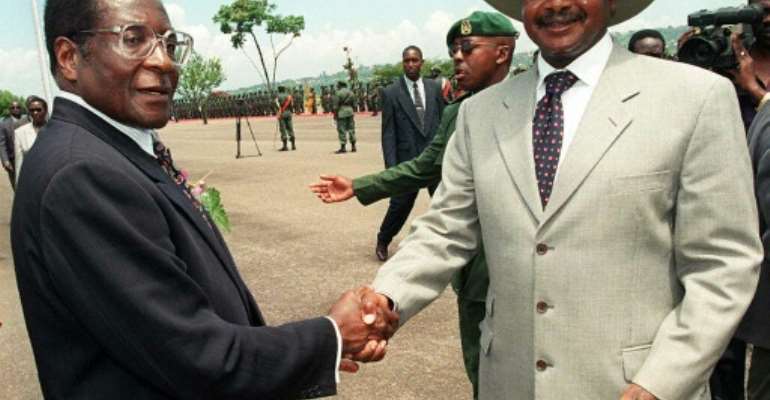The late Zimbabwean leader Robert Mugabe (who was president for 37 years) with Uganda's President Yoweri Museveni (34 years and counting) in 1998. By ALESSANDRO ABBONIZIO (AFP/File)