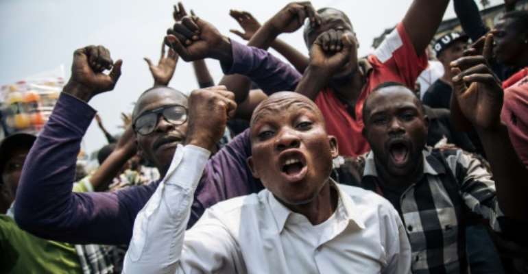 The march was called to protest the DR Congo constitutional court's invalidation of the election of about 20 opposition lawmakers. By ALEXIS HUGUET (AFP)