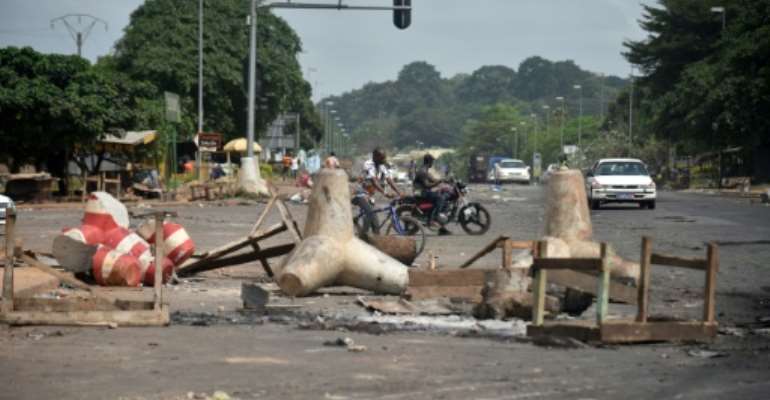 The remains of a street barricade in Yamoussoukro, the Ivorian capital, after post-election clashes. By SIA KAMBOU (AFP)