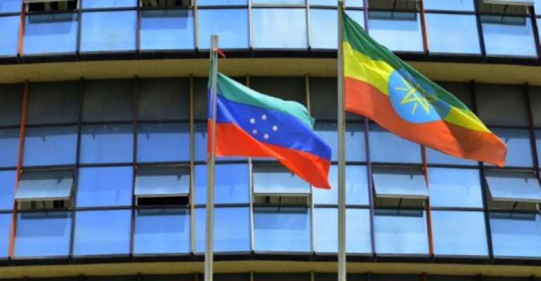 The unofficial green, blue and red flag of the advocated region for the Sidama ethnic group (L), the largest in southern Ethiopia, flies next to the Ethiopian national standard at Hawassa city. By Michael TEWELDE (AFP)