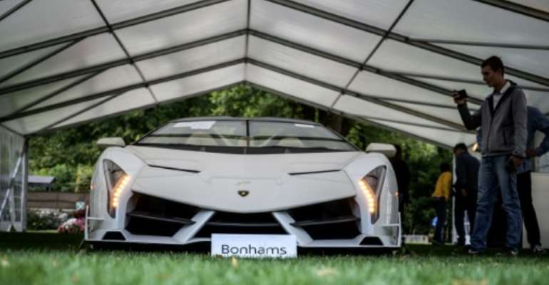 This Lamborghini Veneno Roadster one of only nine in the world, fetched a world record 7.6 million euros. By FABRICE COFFRINI (AFP)
