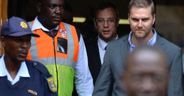 South African Paralympic track star Oscar Pistorius (C) leaves the North Gauteng High Court in Pretoria on April 17, 2014. By Mujahid Safodien (AFP)