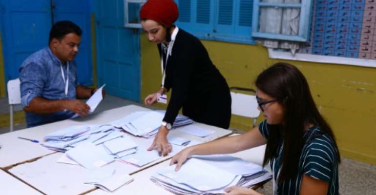 Tunisian volunteers count ballots at a polling station in Sousse, south of the capital Tunis. By ANIS MILI (AFP)