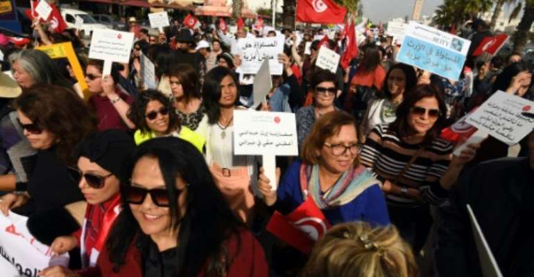 Tunisians protest in March 2018 in support of equal inheritance rights for women, one of several reforms currently opposed by conservative Muslim groups across the country. By FETHI BELAID (AFP/File)