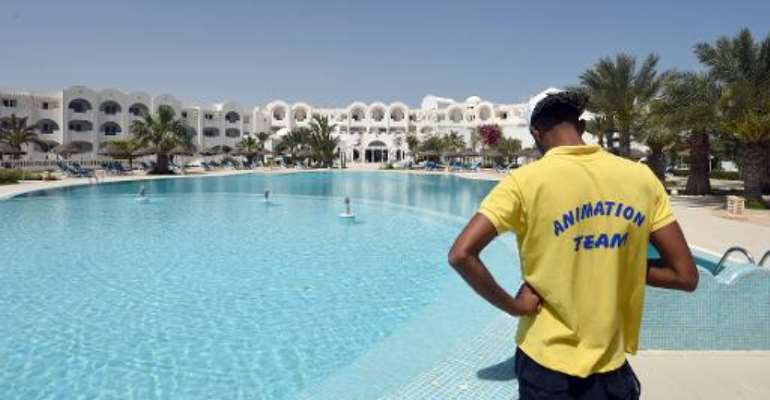 It's another sun-drenched day but the deckchairs of a four-star hotel on the island of Djerba stand empty, in a sign of the