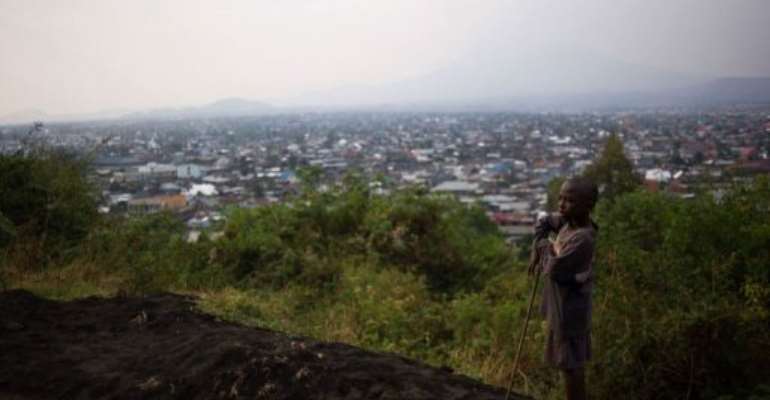 A boy stands on Mt. Goma overlooking the capital of North Kivu in the Democratic Republic of the Congo on August 1, 2013. By Phil Moore (AFP)