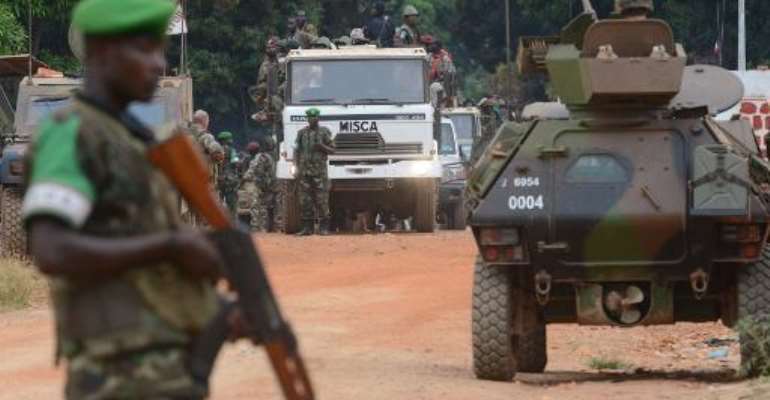 Former Seleka militants are escorted by French troops of the Sangaris operation and Rwanda's MISCA peacekeepers out of Kassai military camp in Bangui on their way to another camp outside the city on January 28, 2014. By Issouf Sanogo (AFP)