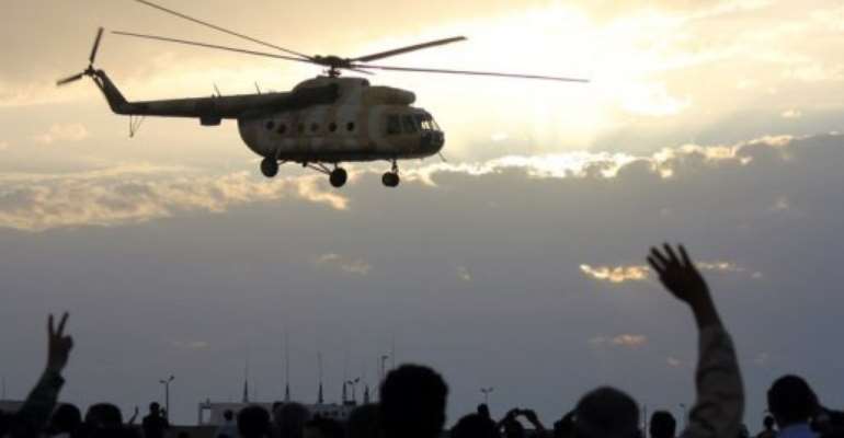 A helicopter flies over Benghazi during a military display. By Abdullah Doma (AFP/File)