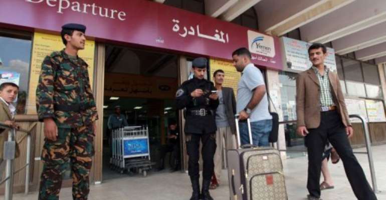 People present their documents before entering the departure lounge at Sanaa International Airport on August 6, 2013. By Mohammed Huwais (AFP)