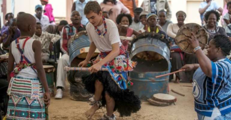 Kyle Todd (C) dances during his initiation ceremony to become a Sangoma at a traditional healer school in Pretoria, South Africa. By Mujahid Safodien (AFP)
