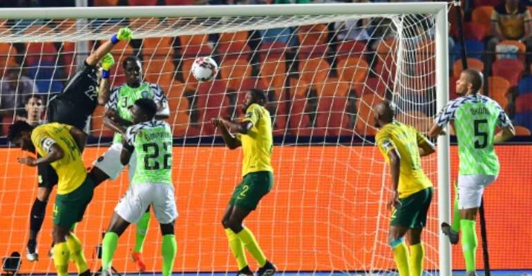 William Troost-Ekong (R) pounced after South Africa goalkeeper Ronwen Williams failed to deal with a corner. By Giuseppe CACACE (AFP)