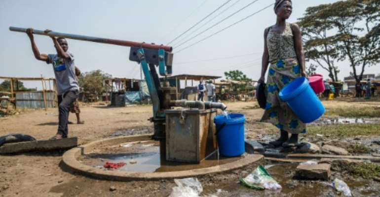 Working class residents like these in the Harare suburb of Glen View rely on water pumped from a boreholes drilled by a donor or city authorities. By Jekesai NJIKIZANA (AFP/File)