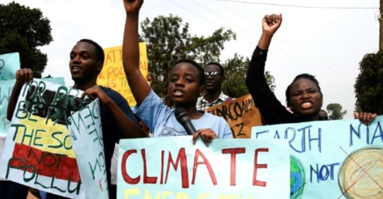 Young people took part in a march against climate change. By ISAAC KASAMANI (AFP)