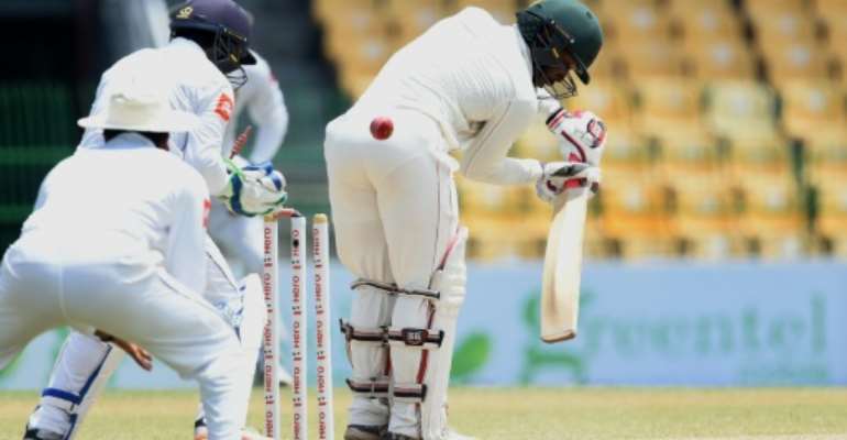 Zimbabwe's Regis Chakabva (pictured, R, batting against Sri Lanka in July 2017) hit an unbeaten 71 as West Indies were denied victory in Bulawayo. By Ishara S. KODIKARA (AFP/File)