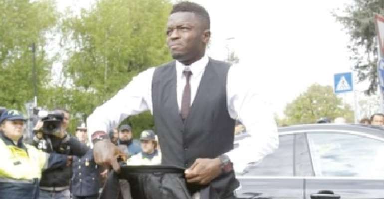 Time for serious business: Sulley Muntari arrives at his office, 4FK MotorSport, where cars are pimped for millionaires and super stars.