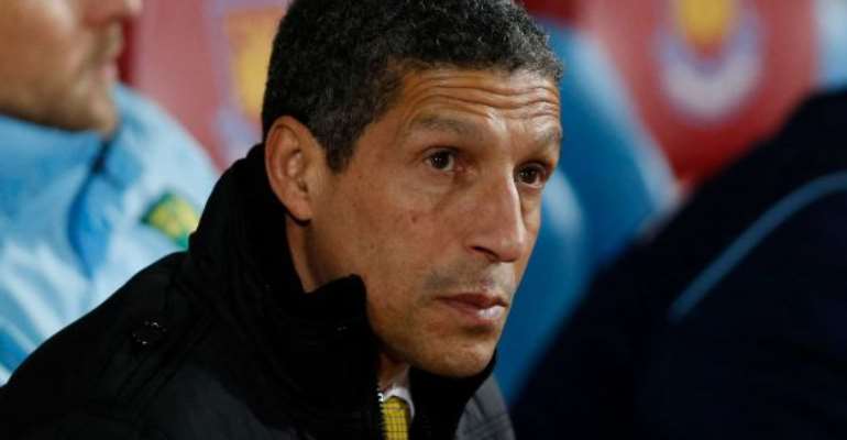 Chris Hughton looks on from the dugout before the start of their English Premier League soccer match against West Ham United at Upton Park, London