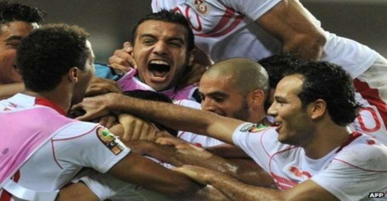 Tunisia's players celebrate a massive opening win over neighbours Morocco