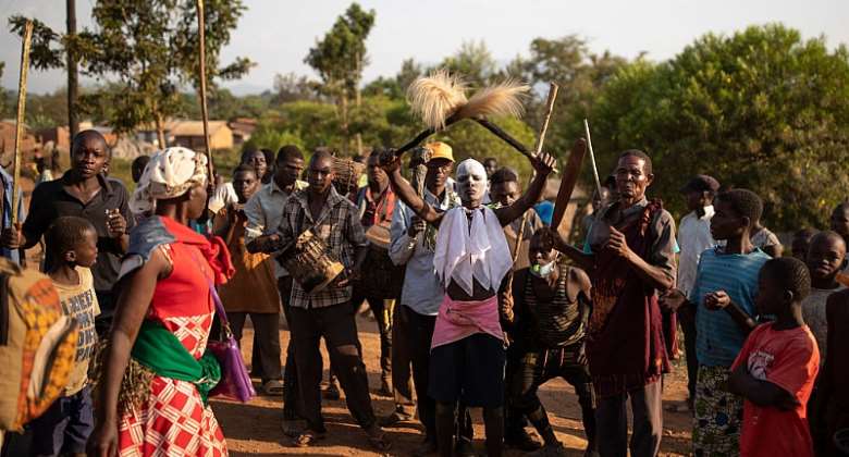 Amirr centre parades though his village ahead of the imbalu circumcision ritual. Imbalu begins with dance and music, as initiates visit relatives and friends to receive gifts. - Source: Luke DreyGetty Images
