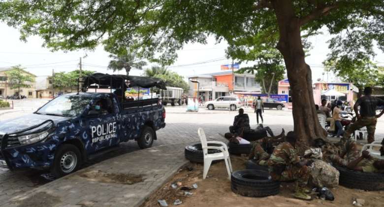 Police officers and soldiers in Cotonou, Benin on April 12, 2021. At least two journalists were jailed in 2021 under the country's digital code after a report in their newspaper was shared on social media. AFPPius Utomi Ekpei