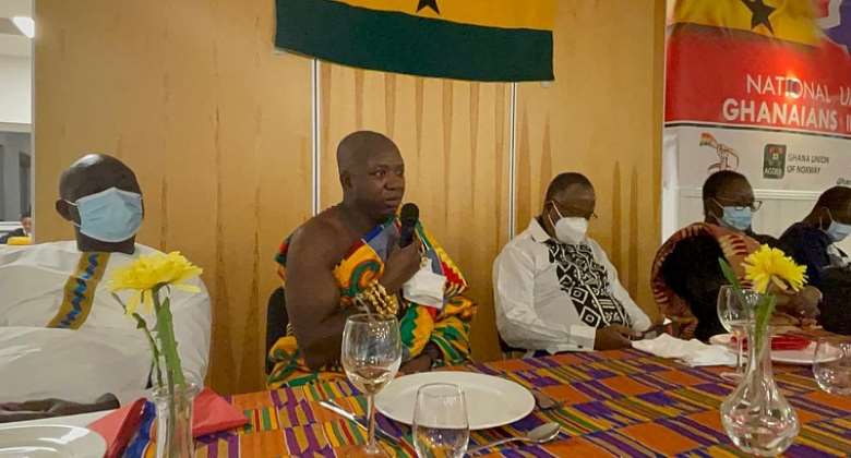 Nana KotaÂ  Ntiamoah (with microphone dressed in cloth) speaking during the inauguration of the NUGN in Bergen. Seated with him are the Ghana's Ambassador to Norway, Jennifer Lartey and her team from the Ghana Embassy, Oslo