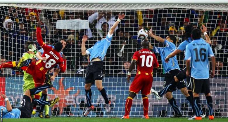 Luis Suarez third from right kept out a header from Dominic Adiyiah which could have seen Ghana become the first African nation to reach the World Cup semi-finals
