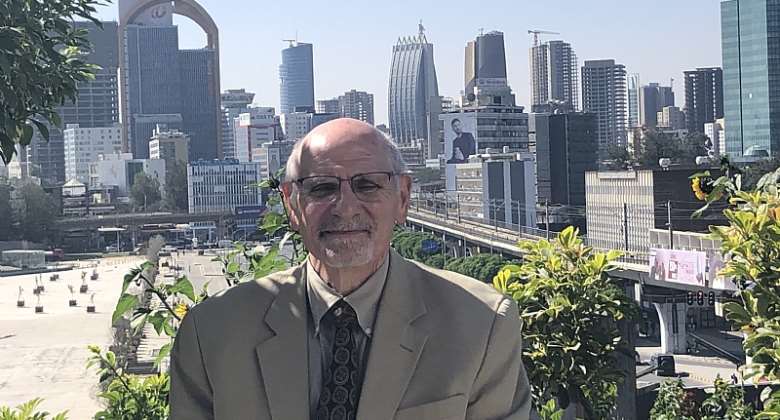 Lawrence Freeman standing in front of the Addis Ababa skyline