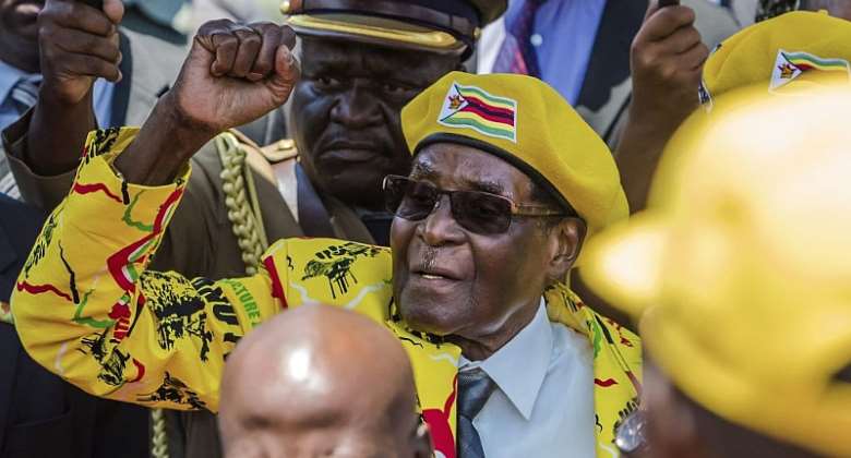 Former Zimbabwean President Robert Mugabe greets supporters massed at his party headquarters shortly before his ouster in 2017.  - Source: Jekesai NjikizanaAFP via Getty Images
