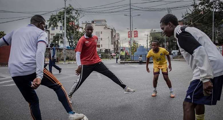 Young people play football on a street in Goma, eastern DRC.  - Source: Guerchom NdeboAFP via Getty Images