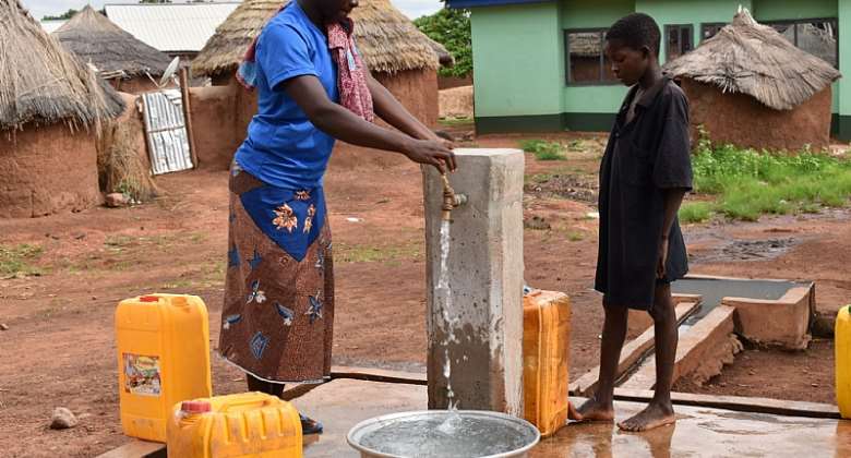 Young people fetching water in a local communityCredit UNIC Accra