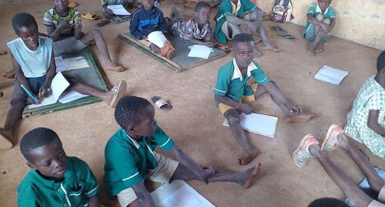 Pupils of Eggu R/C Primary School lie on bare floor to study, write exams