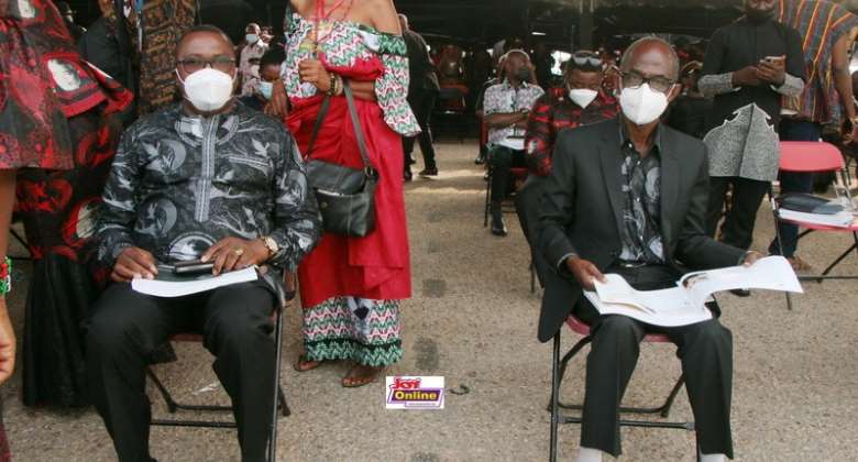 NDC national chairman and general secretary at Rawlings' state funeral. NDC supporters behind them.