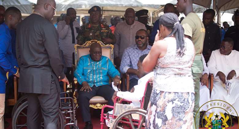 President Akufo-Addo having a hearty chat with the disabled student
