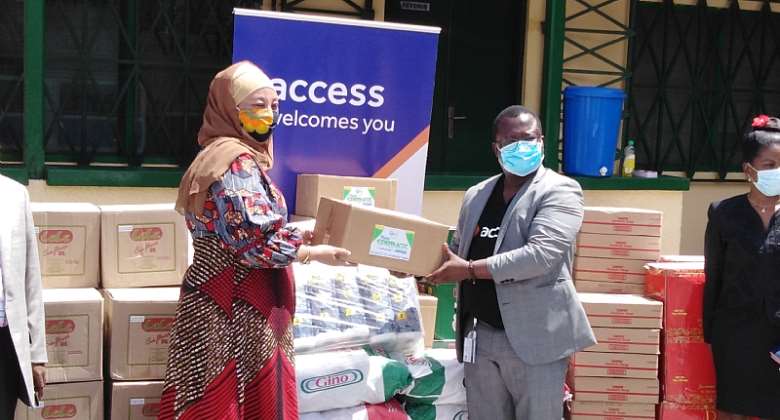 Hajia Salma (left) receiving the items from Mr. Jude Atubigah of the Access Bank