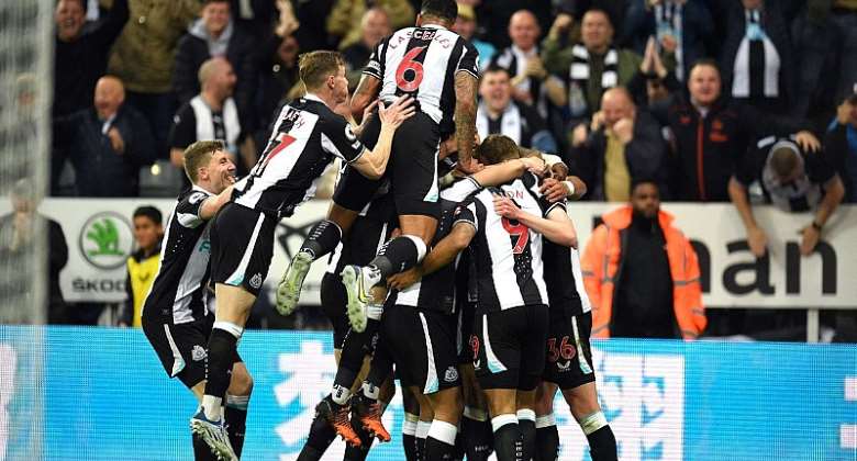 Callum Wilson is mobbed by teammates after Ben White's own goal hands Newcastle the lead over ArsenalImage credit: Getty Images