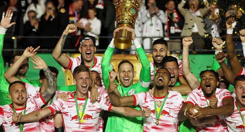Leipzig's Hungarian goalkeeper Peter Gulacsi C and his teammates celebrate with the trophy after the German Cup final football match between SC Freiburg and RB Leipzig at the Olympic Stadium in Berlin on May 21, 2022.Image credit: Getty Images