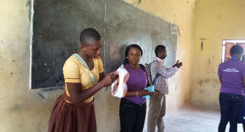 A girl demonstrating how to use a sanitary pad during the programme