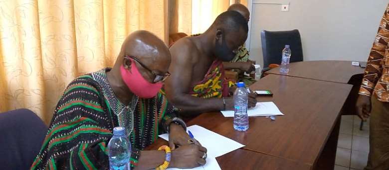 Bogoso Chief Nana Akwasi Sompreh II right and Boppoh Chief Nana Atta Kojo Bremebi sign the MOU.