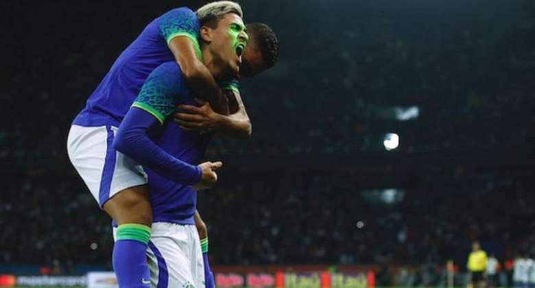 Brazil's Pedro celebrates scoring his goal against Tunisia as a laser is shone onto his face