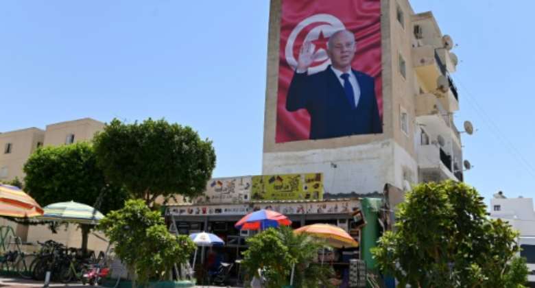 A billboard depicting Tunisia's President Kais Saied hangs on the side of a building in the central city of Kairouan, on July 26, 2022.  By Kabil BOUSENA AFPFile