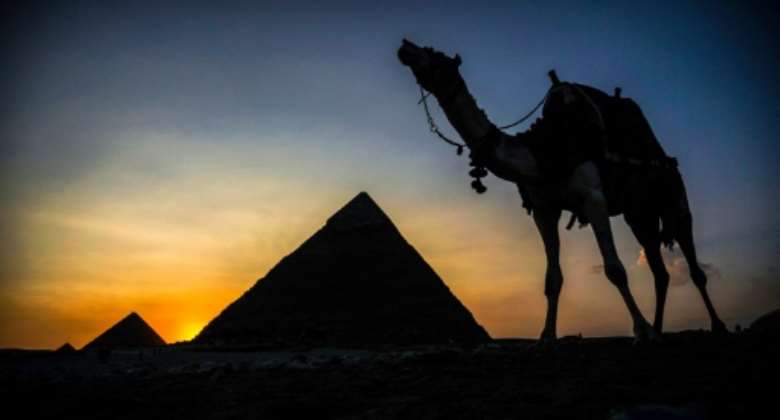 A camel walks past the pyramid of Khafre (also known as Chephren) at the Giza pyramids necropolis on the southwestern outskirts of the Egyptian capital Cairo.  By Mohamed el-Shahed (AFP/File)