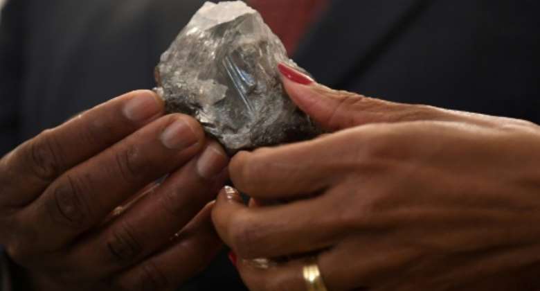 A member of the Botswana cabinet holds the 1,174-carat diamond in Gaborone on Wednesday.  By Monirul Bhuiyan AFP