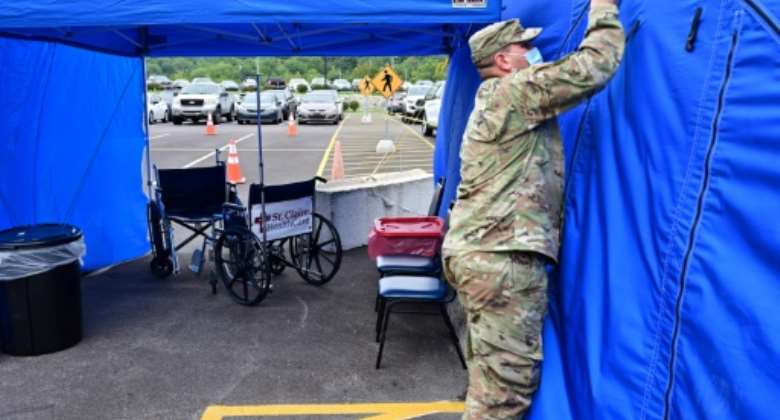 A National Guardsman erects a tent for Covid patients outside a hospital in Kentucky last month. The WHO is hoping that member states will come up with methods to prepare for the next pandemic, warning that 'the question is not if, but when'.  By Jon Cherry (GETTY IMAGES NORTH AMERICA/AFP)