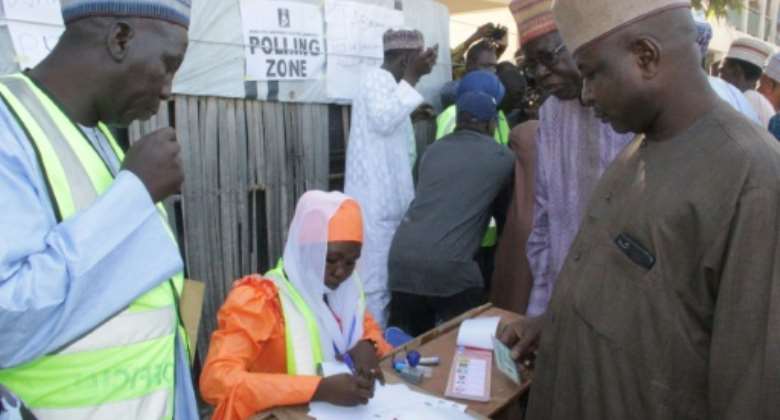 A polling station official registers voters during local elections in Maiduguri on November 28, 2020..  By Audu MARTE AFP