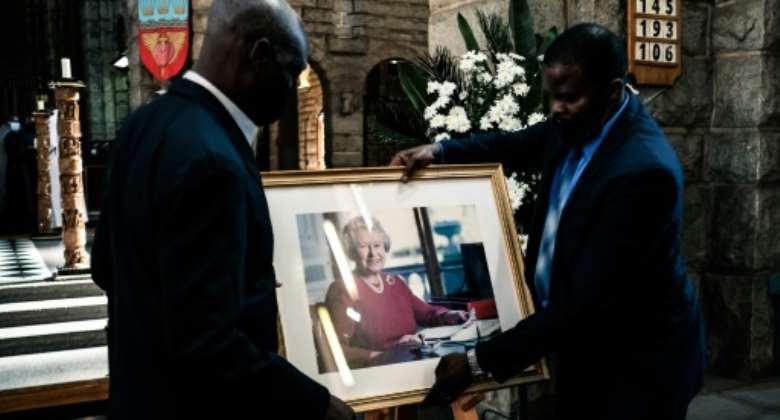A portrait of the queen is placed on a stand ahead of a thanksgiving service at the Anglican Cathedral.  By Jekesai NJIKIZANA AFP