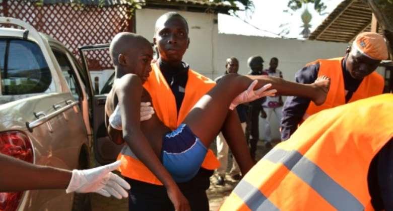 A rescue worker carries a young boy who was wounded in the attack.  By Sia KAMBOU AFPFile