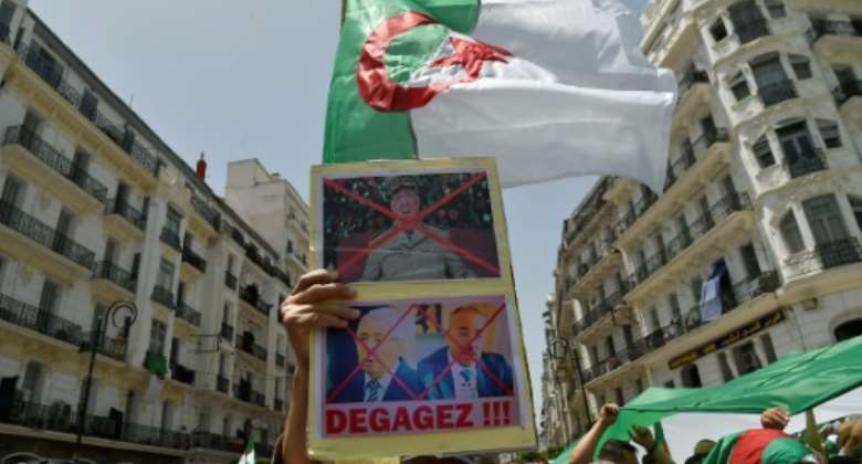 Algerians demonstrate for a 16th consecutive Friday demanding a political overhaul in the North African country after the ouster in April of veteran president Abdelaziz Bouteflika before new presidential polls can be held.  By RYAD KRAMDI (AFP)