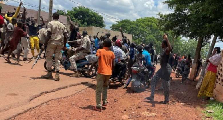 An angry crowd gathered at Kati after the attack, accusing a man not pictured of being one of the assailants.  By - AFPFile