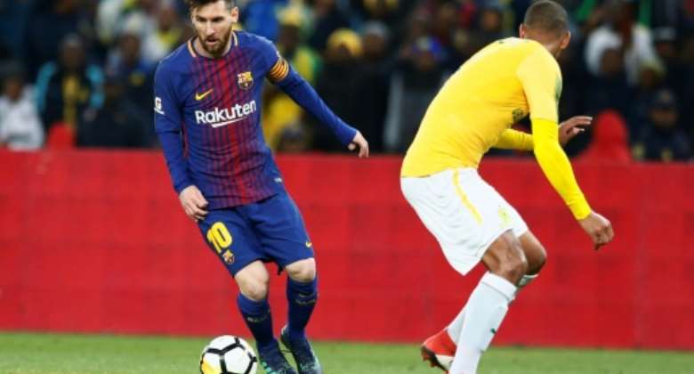 Argentine superstar Lionel Messi L playing for Barcelona last year at Soccer City, the Soweto stadium with a 90,000 capacity.  By PHILL MAGAKOE AFP